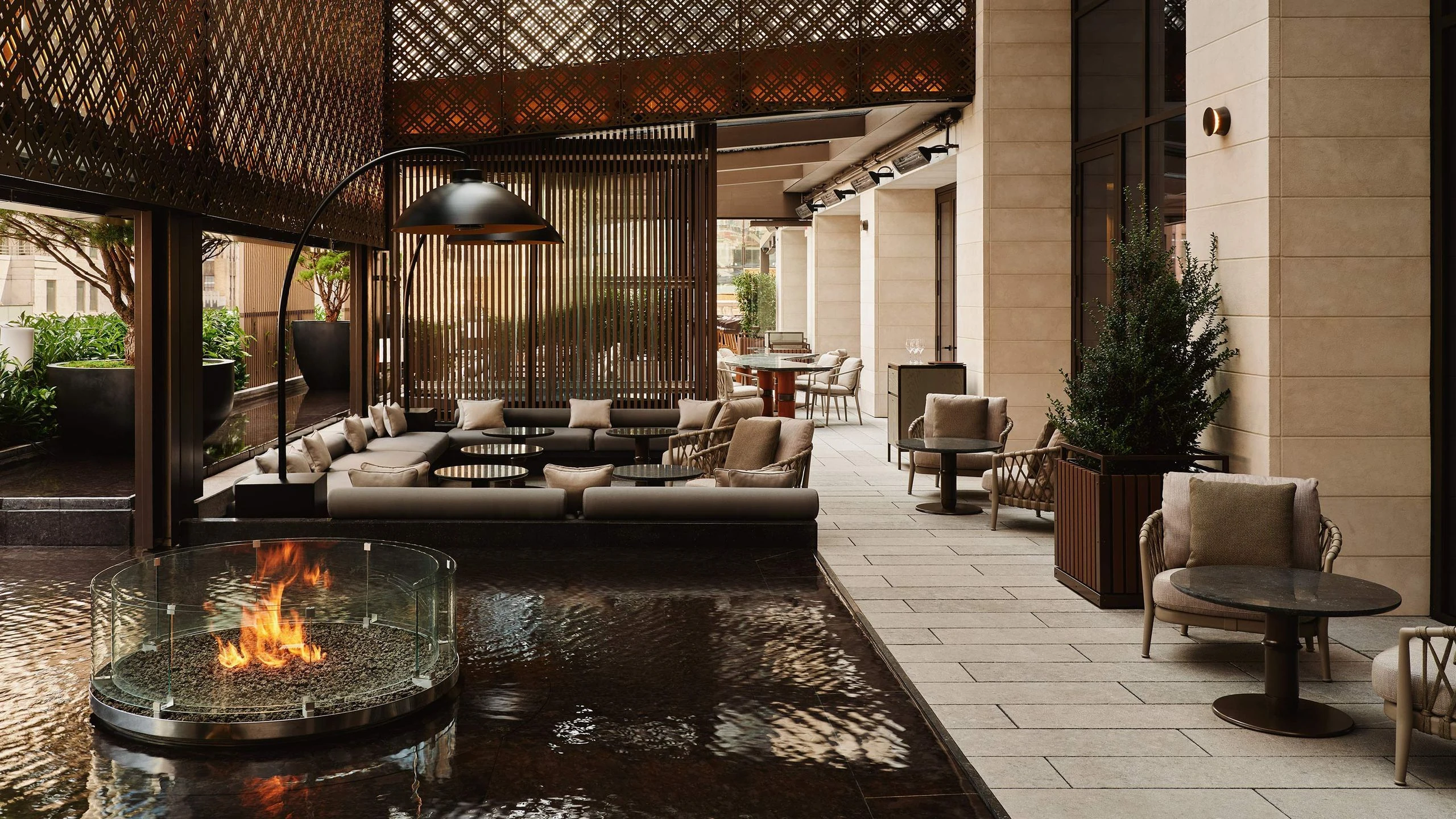 Garden Terrace do Aman New York com lounges, vegetação e lareira